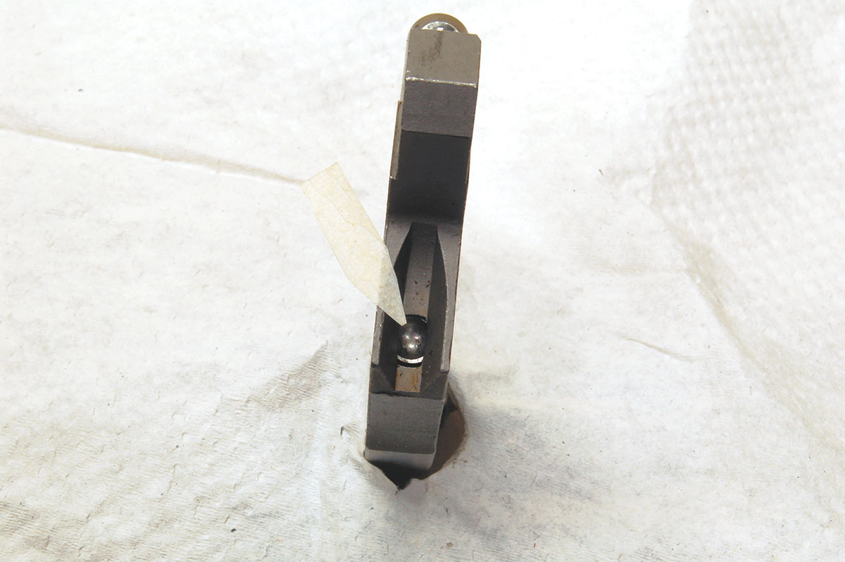 Though a bit hard to see, the mainspring plunger (arrow) has a concave face to match the hammer strut.